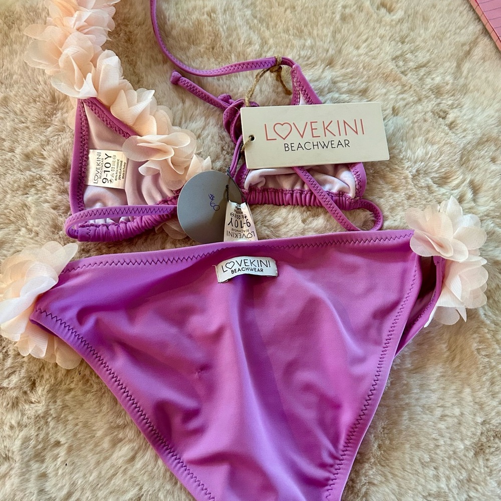 Girls 9-10 pink bikini with off white over the shoulder and hips fringe.
